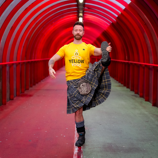 The Kitled Yogi poses inside red domed footpath tunnel